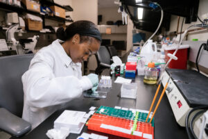 Graduate Student Olive Tambou Nzoutchoum plates brain samples onto slides in the Paz Lab at Gladstone Institutes